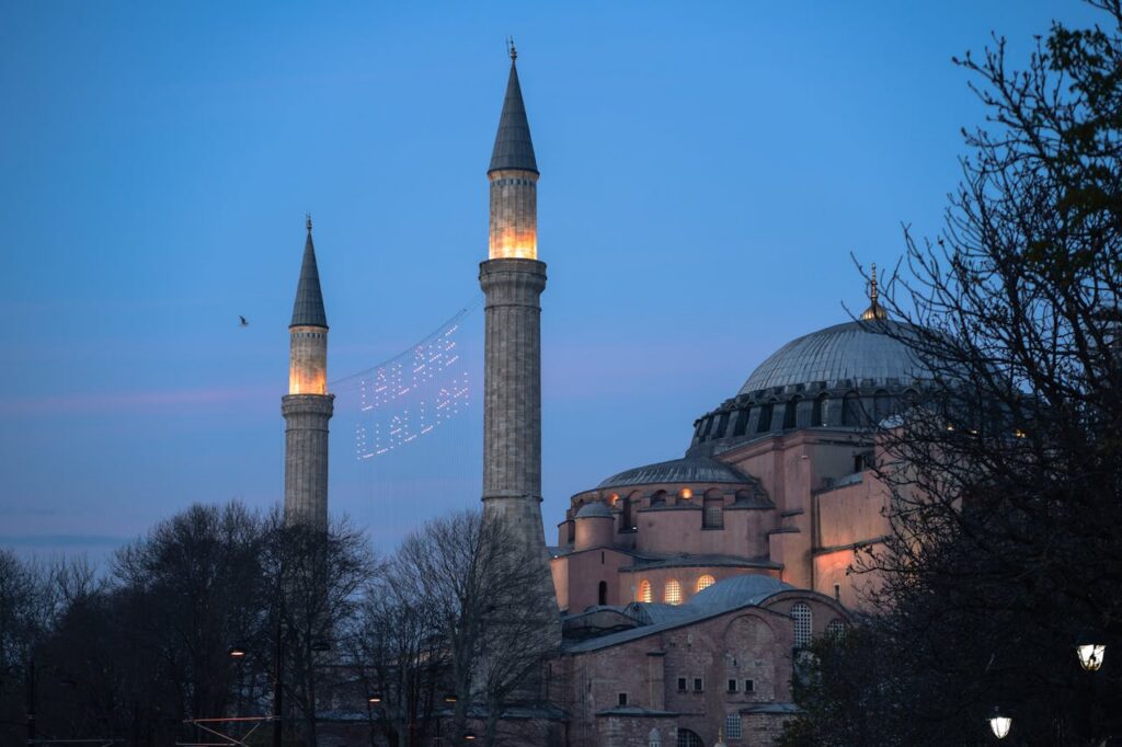 Hagia Sophia's minarets glowing at twilight, Istanbul landmark.