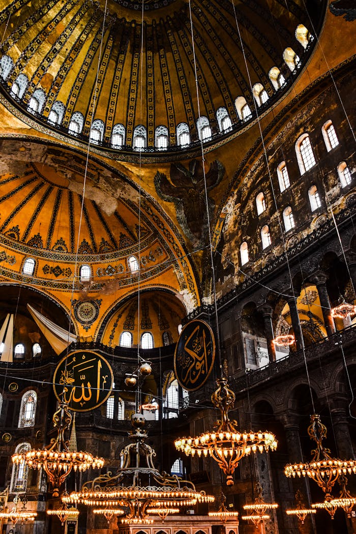 Stunning interior view of the Hagia Sophia's dome with chandeliers in Istanbul, Turkey.