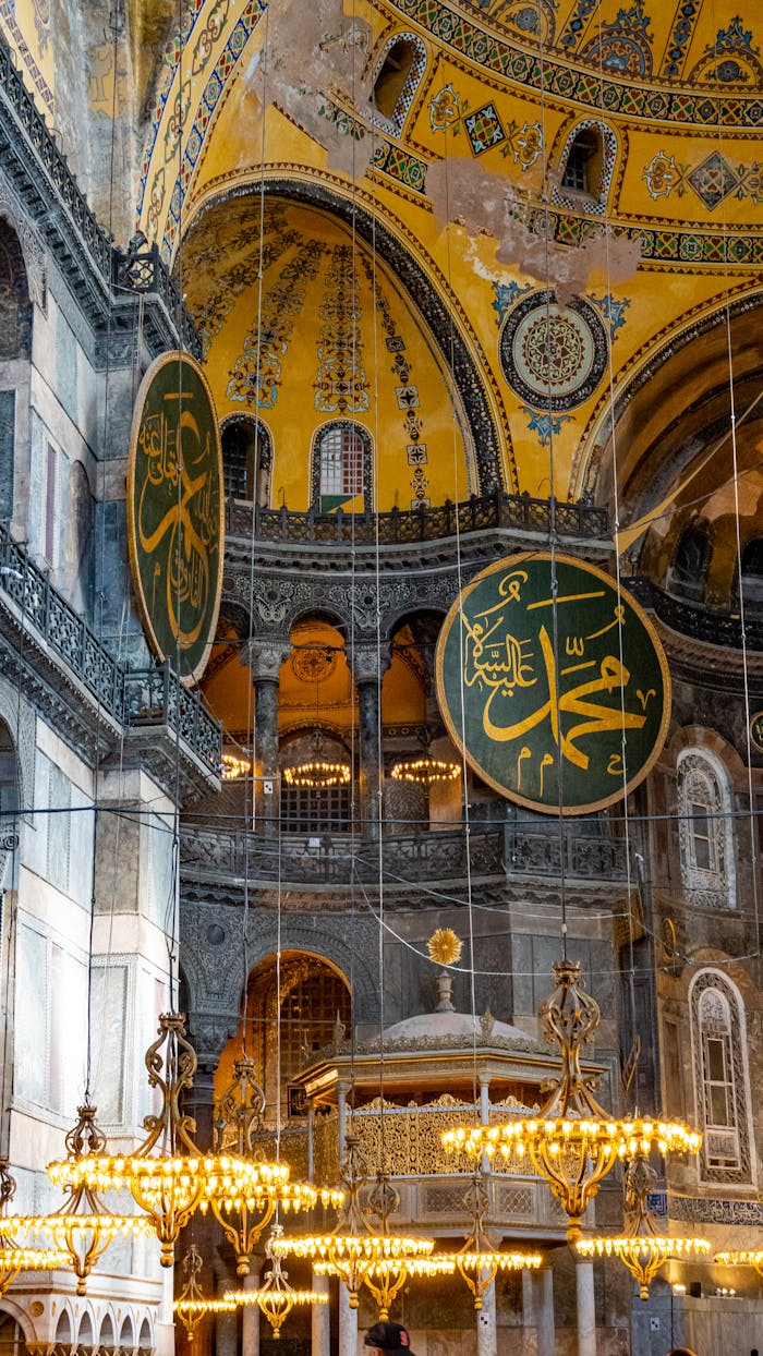 Detailed view of Hagia Sophia's interior with Islamic calligraphy and ornate chandeliers.